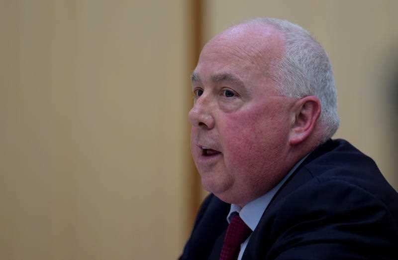 President of the Fair Work Commission Justice Iain Ross speaks during a Senate Estimates hearing at Parliament House