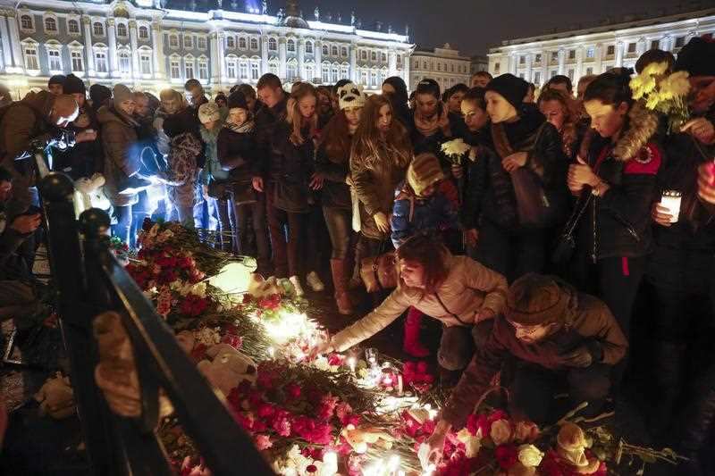 People light candles during a day of national mourning for the plane crash victims at Dvortsovaya (Palace) Square in St. Petersburg, Russia.