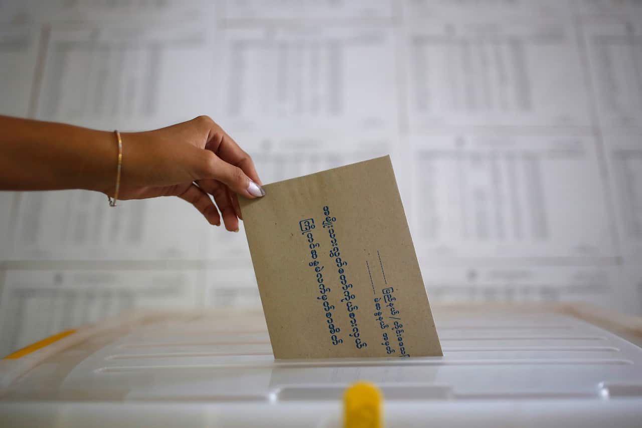 A voter casts a ballot in advance for the upcoming Nov. 8 general election at a township Election Commission Office in Mandalay, Myanmar