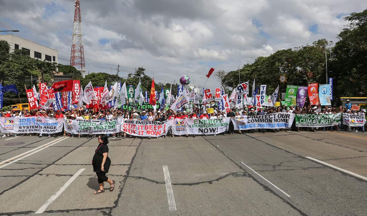 Demonstrators hold banners during the Global Climate March in Quezon City, northeast of Manila, Philippines