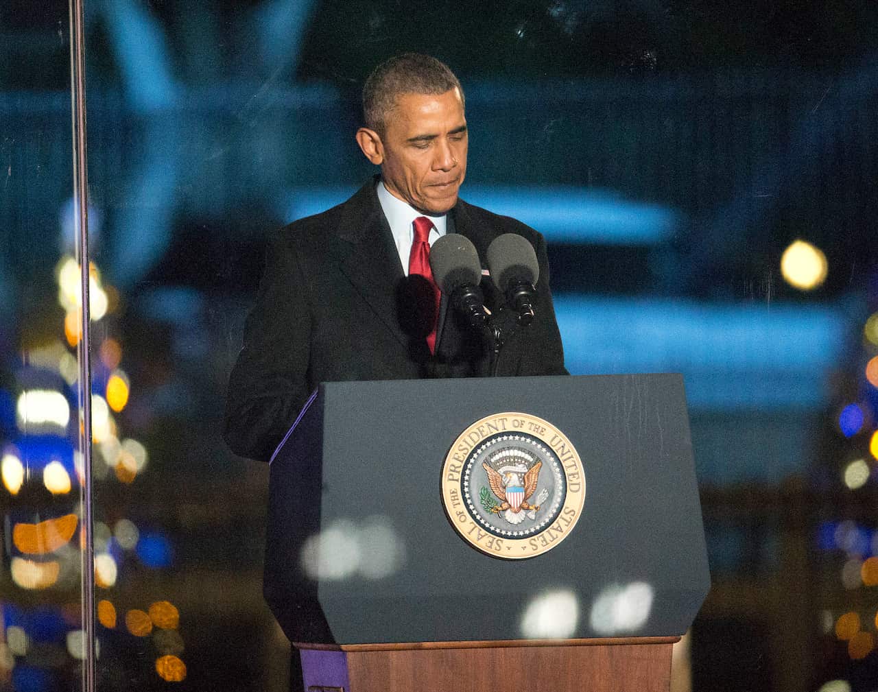 President Barack Obama pauses as he speaks during the National Christmas Tree Lighting ceremony 