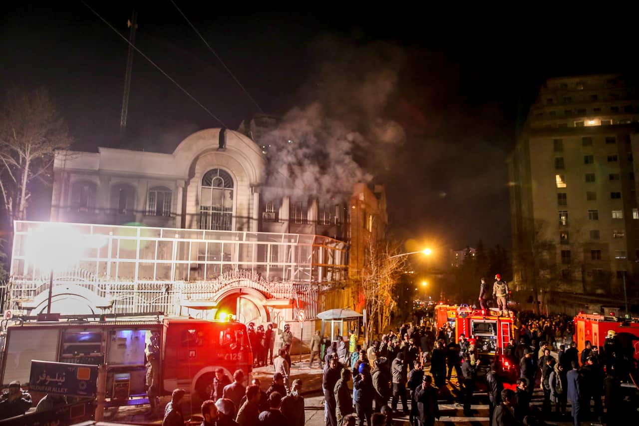 Iranian protesters upset over the execution of a Shiite cleric Sheikh Nimr al-Nimr in Saudi Arabia, set fire to the Saudi embassy in Tehran, while a group of Iranian security protect Saudi Arabia's embassy in Tehran, Iran, Sunday, Jan. 3, 2016.(AP)