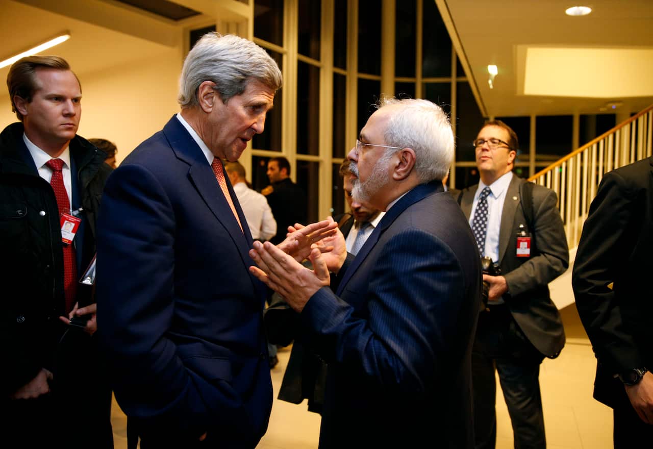 U.S. Secretary of State John Kerry talks with Iranian Foreign Minister Mohammad Javad Zarif, right, after the International Atomic Energy Agency (IAEA) verified that Iran has met all conditions under the nuclear deal, in Vienna, Saturday Jan. 16,  2016. (