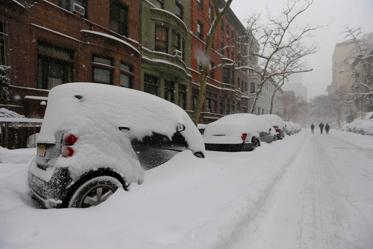 Snow piled high on cars parked on West 71st Street during the first major winter storm in New York, New York, USA, 23 January 2016.