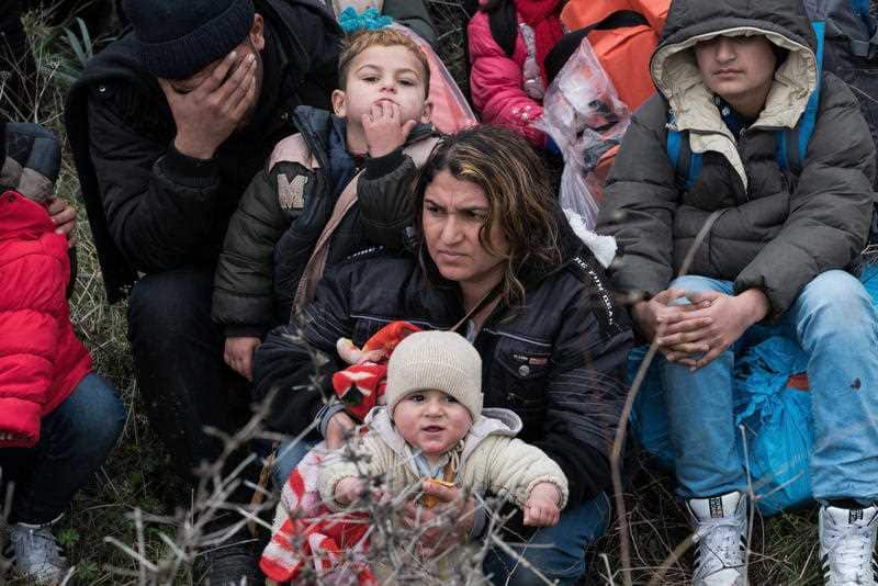 Migrants wait before travelling to Greek island of Lesbos, near Ayvacik