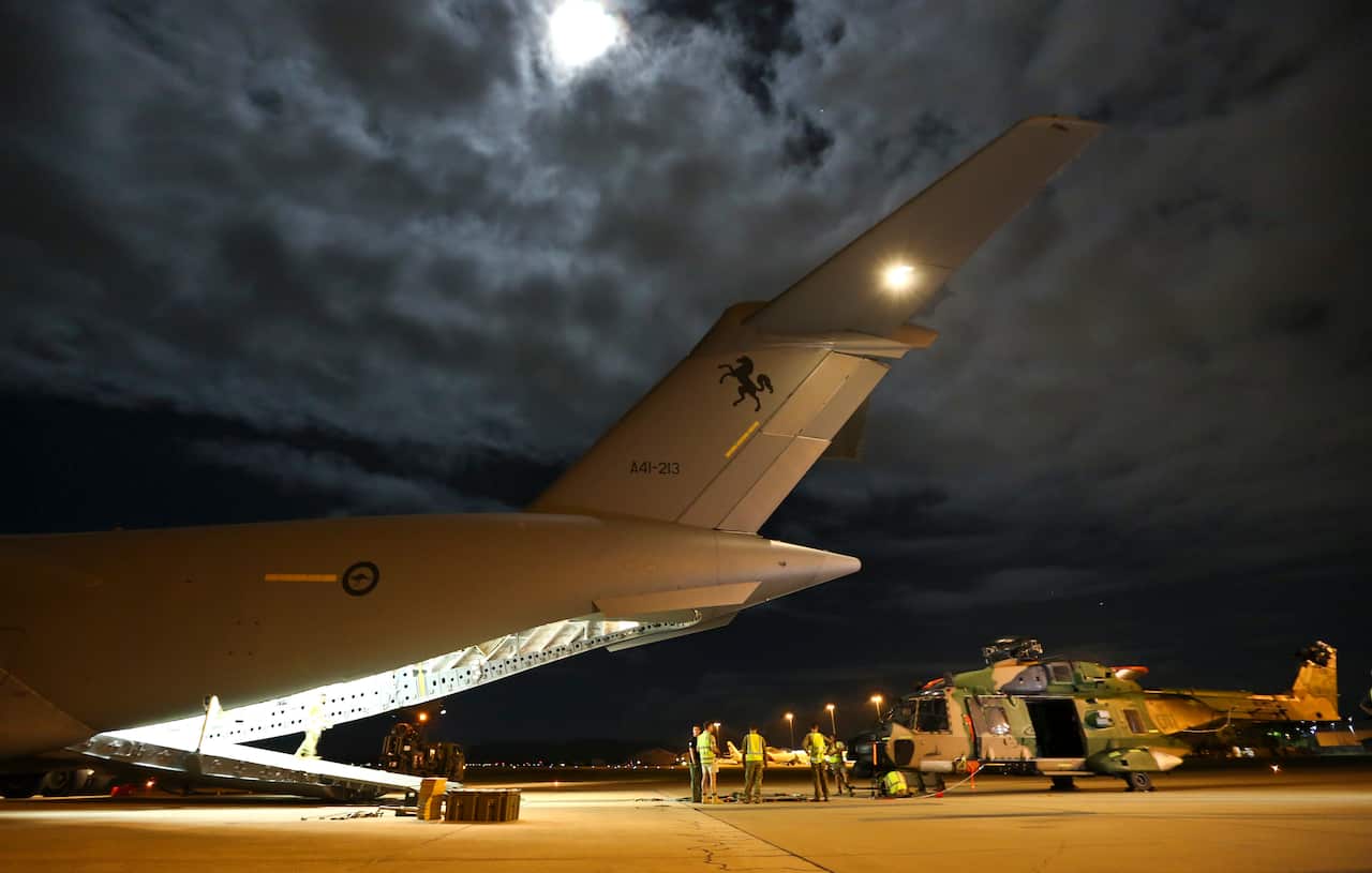 Supplied image obtained Tuesday, Feb. 23, 2016 of Air Force and Army working together to load a Multi Role Helicopter (MRH 90) onto a C-17 Globemaster as part of Operation Fiji Assist.