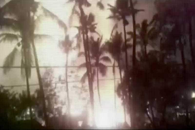In this image made from video, a flash from an explosion is seen from the ground during a fireworks show at a temple in Kollam