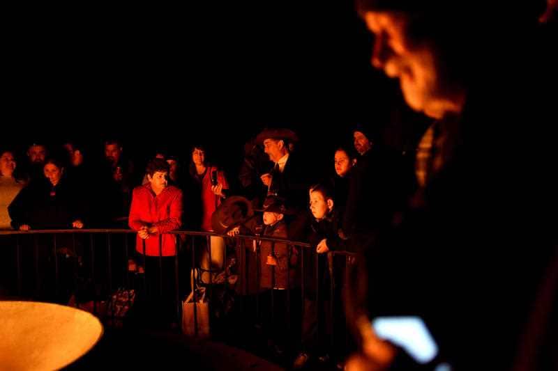 Crowds gather around the eternal flame at the Shrine of Rememberance for the Anzac Day dawn service in Melbourne