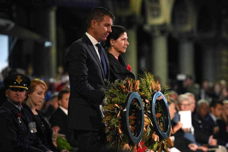 NSW Premier Mike Baird and Federal Senator Concetta Fierravanti-Wells lay wreaths during the Anzac Day dawn service in Sydney, Monday, April 25, 2016.