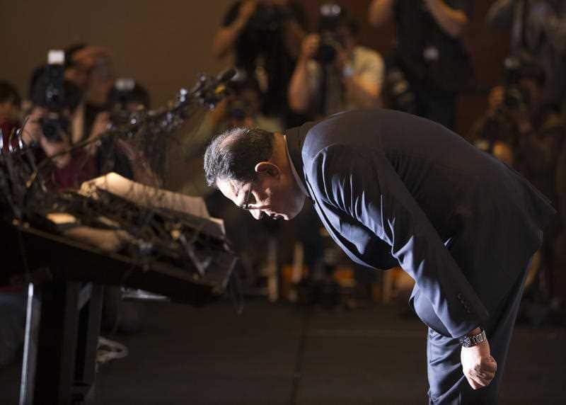 Ata Safdar, head of British firm Reckitt Benckiser Korea, bows during a press conference in Seoul, South Korea
