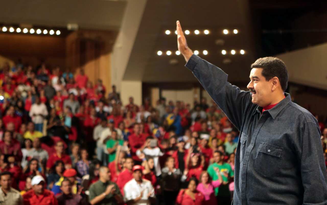 President Nicolas Maduro waving as he takes part in a government act in Caracas