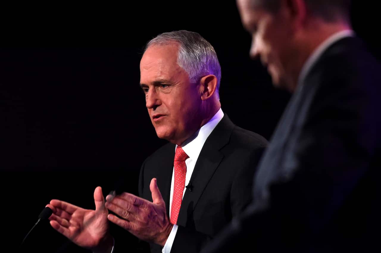 Prime Minister Malcolm Turnbull (left)  speaks as Opposition Leader Bill Shorten listens at the leaders' debate at the National Press Club in Canberra, Sunday, May, 29, 2016. (AAP Image/Tracey Nearmy) NO ARCHIVING