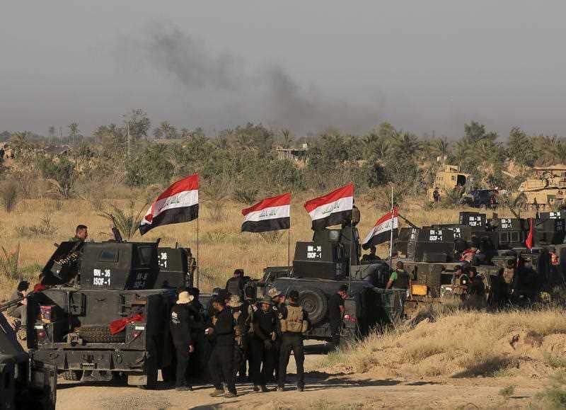 Smoke billows on the horizon as Iraqi military forces prepare for an offensive into Fallujah to retake the city from Islamic State militants in Iraq
