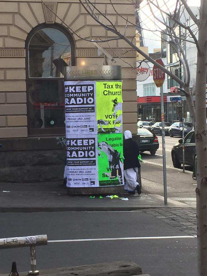 A supplied image obtained Friday, June 3, 2016 of two nuns in Melbourne appear to rip down Sex Party posters calling for churches to be taxed and marijuana to be legalised. (AAP Image/Supplied) NO ARCHIVING, EDITORIAL USE ONLY