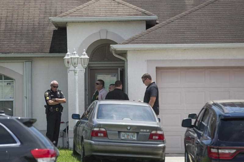 Police stand outside a home related to suspected Orlando club shooter Omar Mateen in Port St. Lucie, Florida