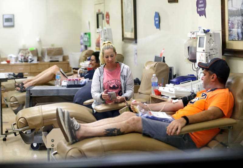 Donors give blood at the OneBlood blood bank in Orlando, Fla., after a shooting involving multiple fatalities at a nightclub, Sunday, June 12, 2016.