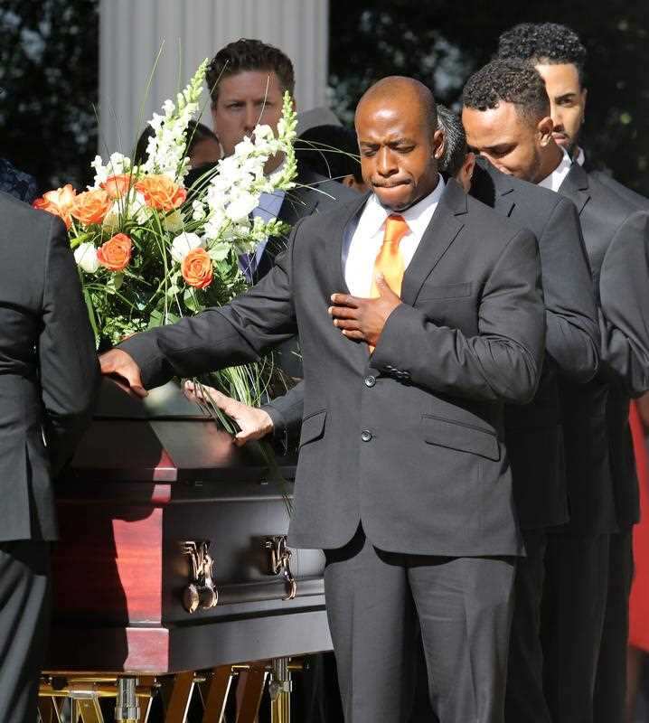 Son Anthony Jones places his hand on his heart as the family processes with the casket of Pulse shooting victim Brenda Lee Marquez McCool