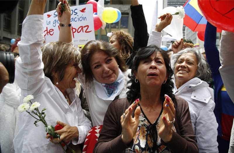 People celebrate the agreement between Revolutionary Armed Forces of Colombia, FARC, and Colombia's government, in Bogota, Colombia, Thursday, June 23, 2016.