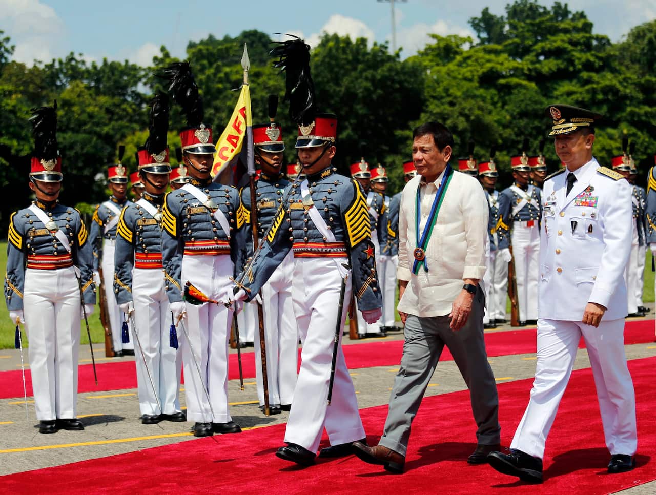 President Duterte reviews honor guards during a visit at a military camp in Quezon city, east of Manila, Philippines.