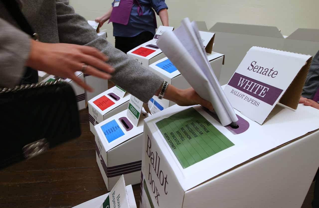 Voting at a polling station at Town Hall in Sydney on 2 July 2016. 