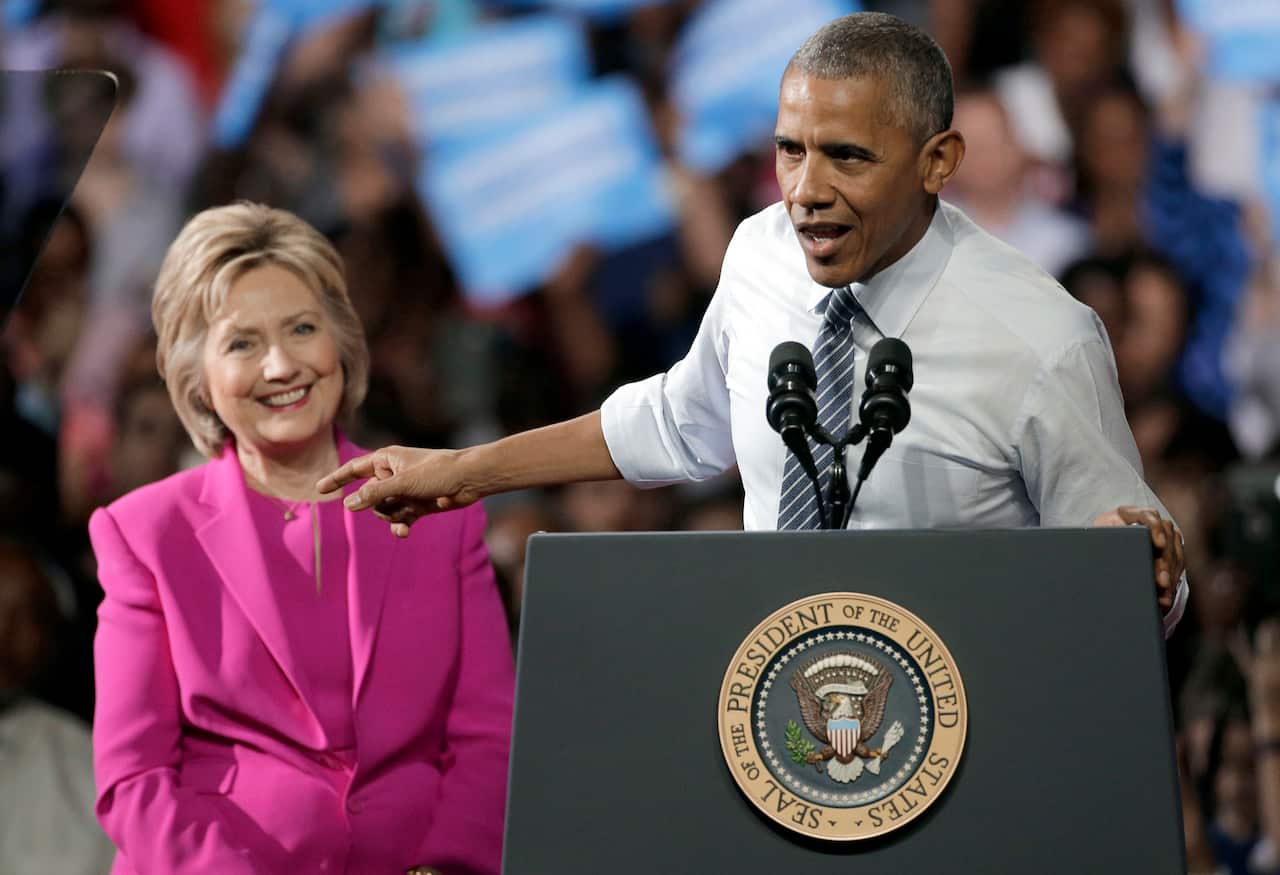 President Barack Obama, right, points to Democratic presidential candidate Hillary Clinton as he speaks during a campaign rally for Clinton in Charlotte, N.C., Tuesday, July 5, 2016. (AP Photo/Chuck Burton)