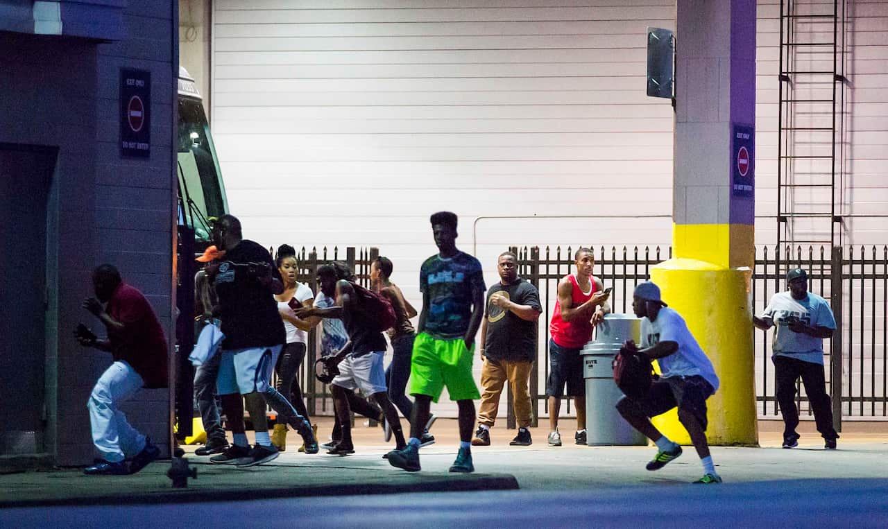 Bystanders run for cover after shots fired at a Black Live Matter rally in downtown Dallas