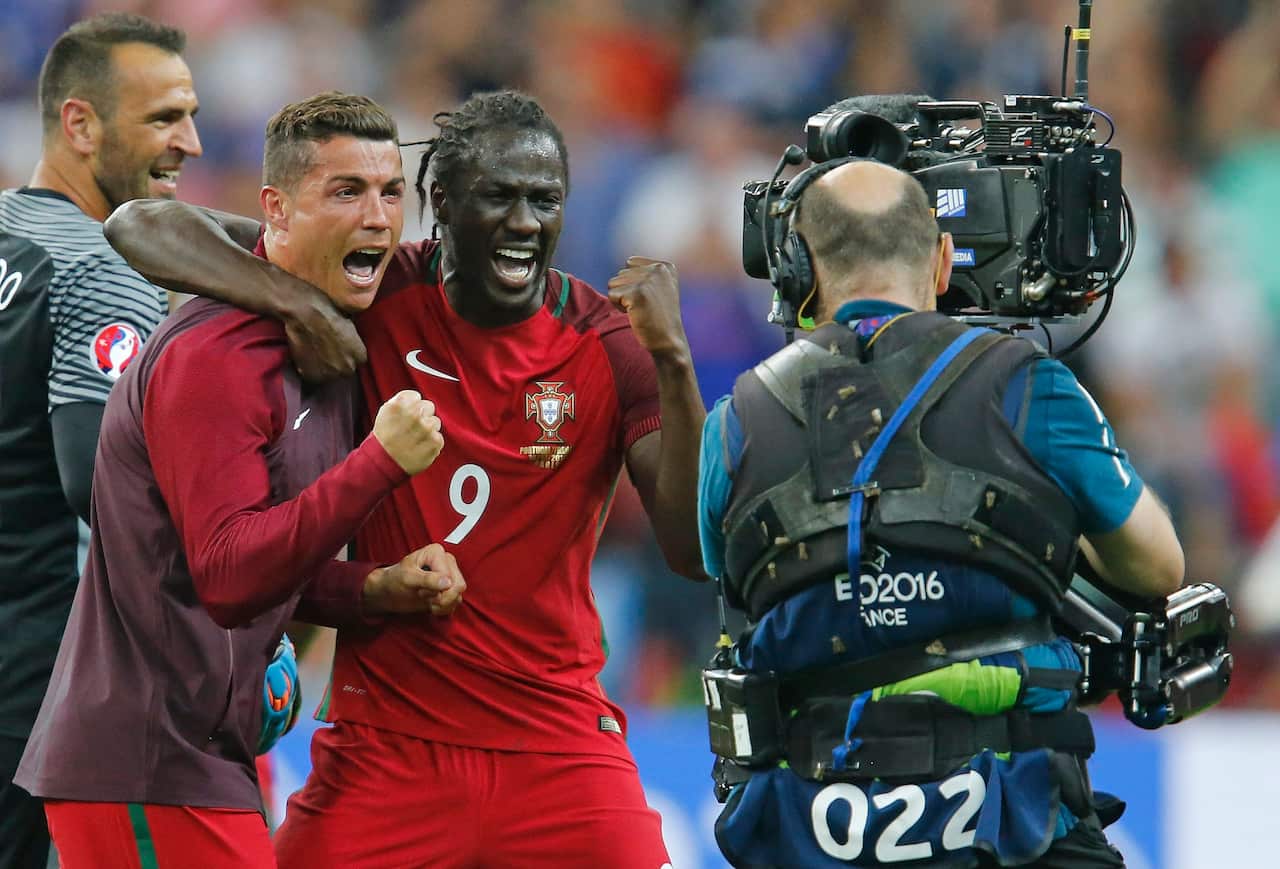 Portugal's Cristiano Ronaldo, left, and Eder celebrate at the end of the Euro 2016 final soccer match between Portugal and France