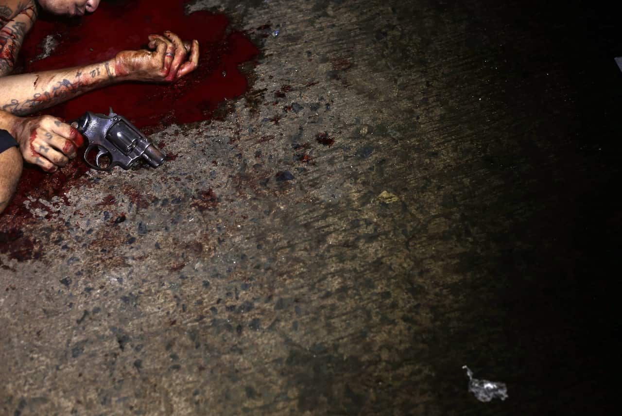 The body of a killed Filipino allegedly involved in illegal drugs lying in a pool of blood in Manila.