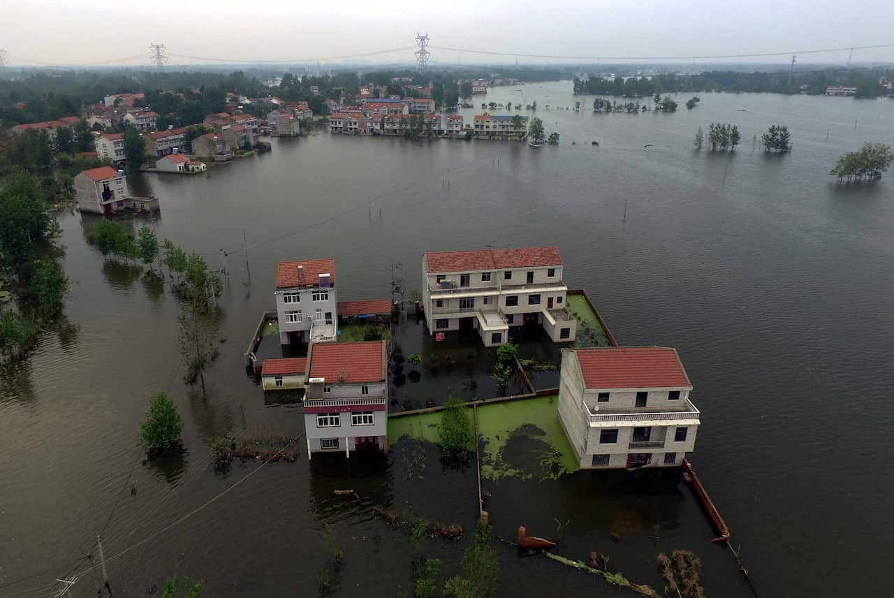 A picture made available on 23 July 2016 of an aerial view of waters flooding Xinhua Village of Xinchang county in Wuhan city.