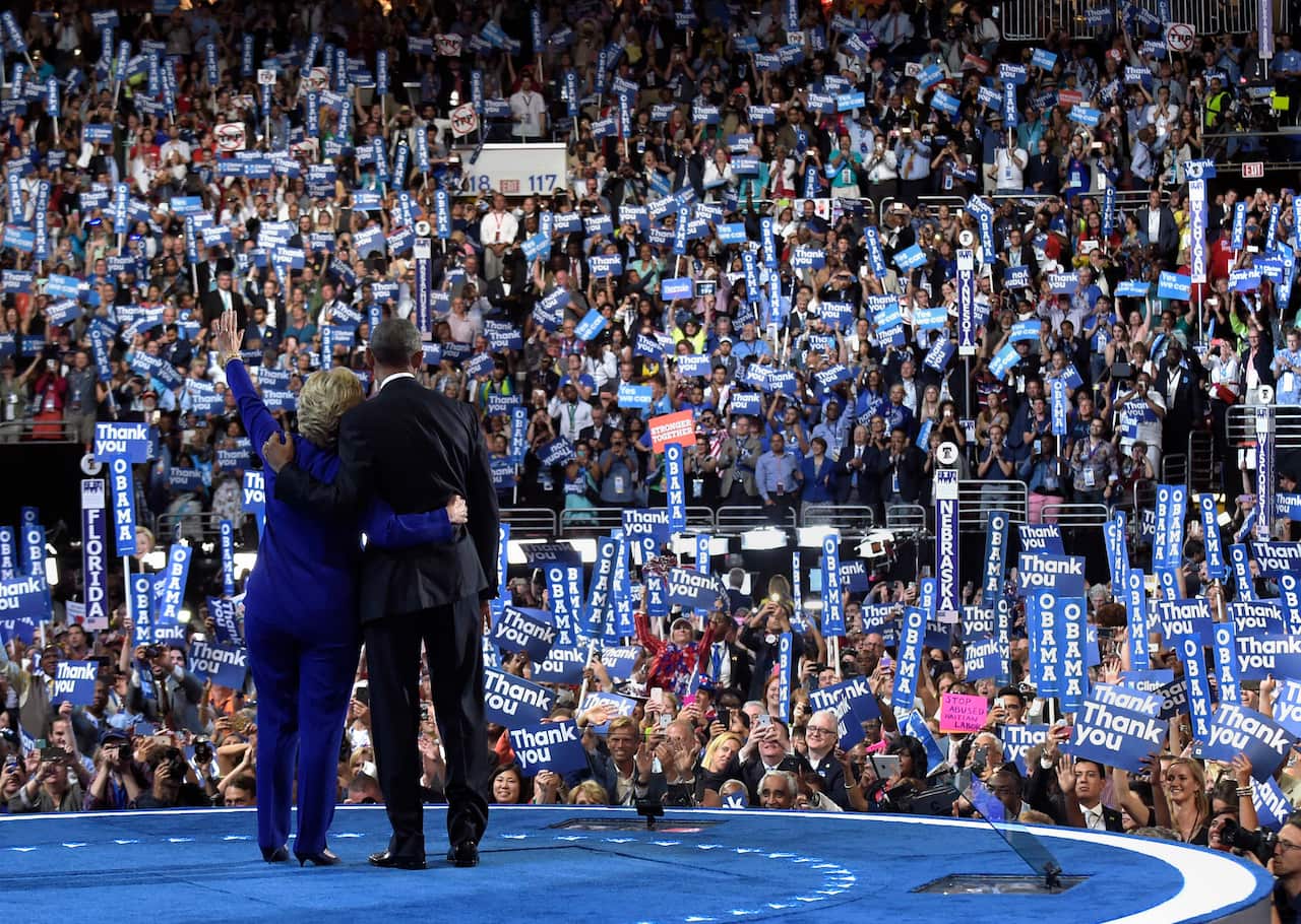 President Barack Obama, right, and Democratic presidential candidate Hillary Clinton, left, wave to the crowd following Obama's speech at the Democratic National Convention in Philadelphia, Wednesday, July 27, 2016. (AP Photo/Susan Walsh)