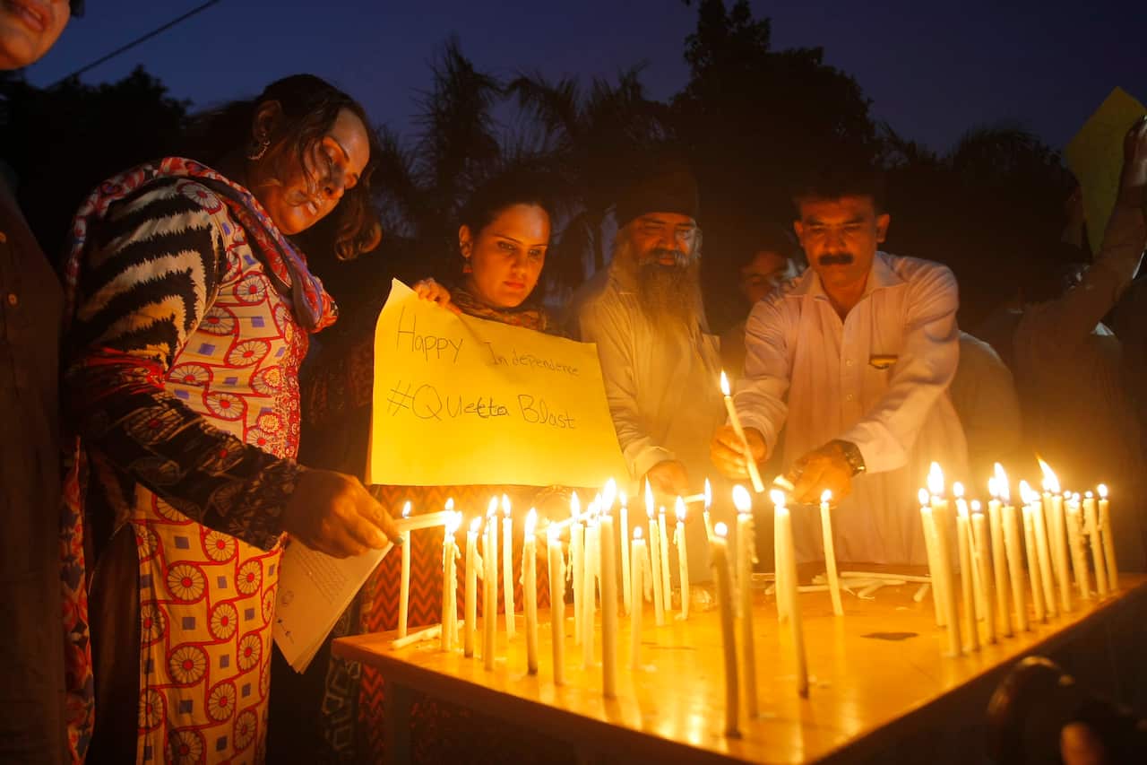 Activists of Pakistan's civil society light candles to pay tribute to the victims of bombing, in Peshawar, Pakistan, Monday, Aug. 8, 2016