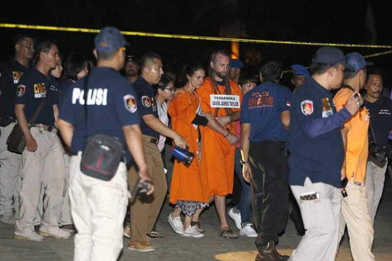Australian Sara Connor and British national David Taylor participate in the reconstruction of the death of a police officer at Kuta beach in Bali, Indonesia.