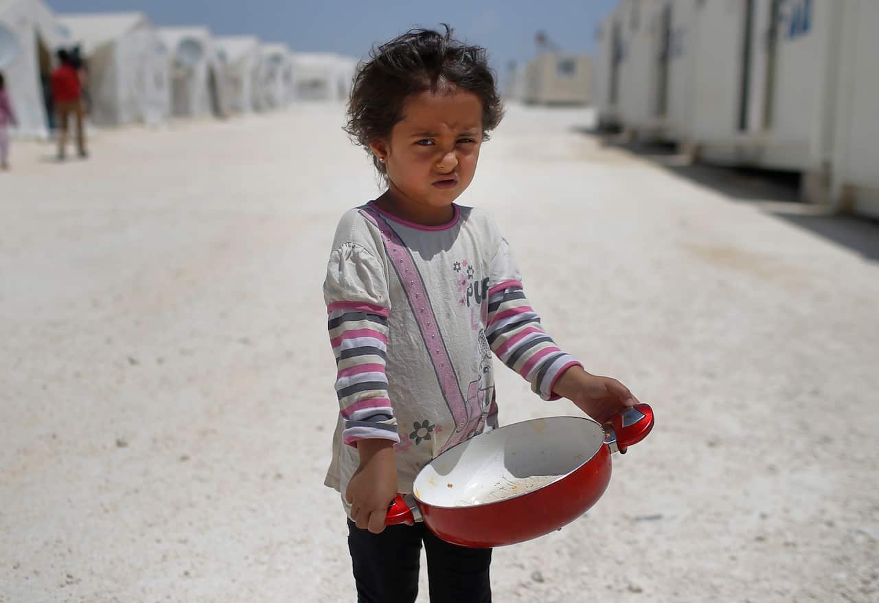 Syrian refugee child walks at a refugee camp in Suruc, on the Turkey-Syria border. 28 million children around the globe are refugees (AP Photo/Emrah Gurel).