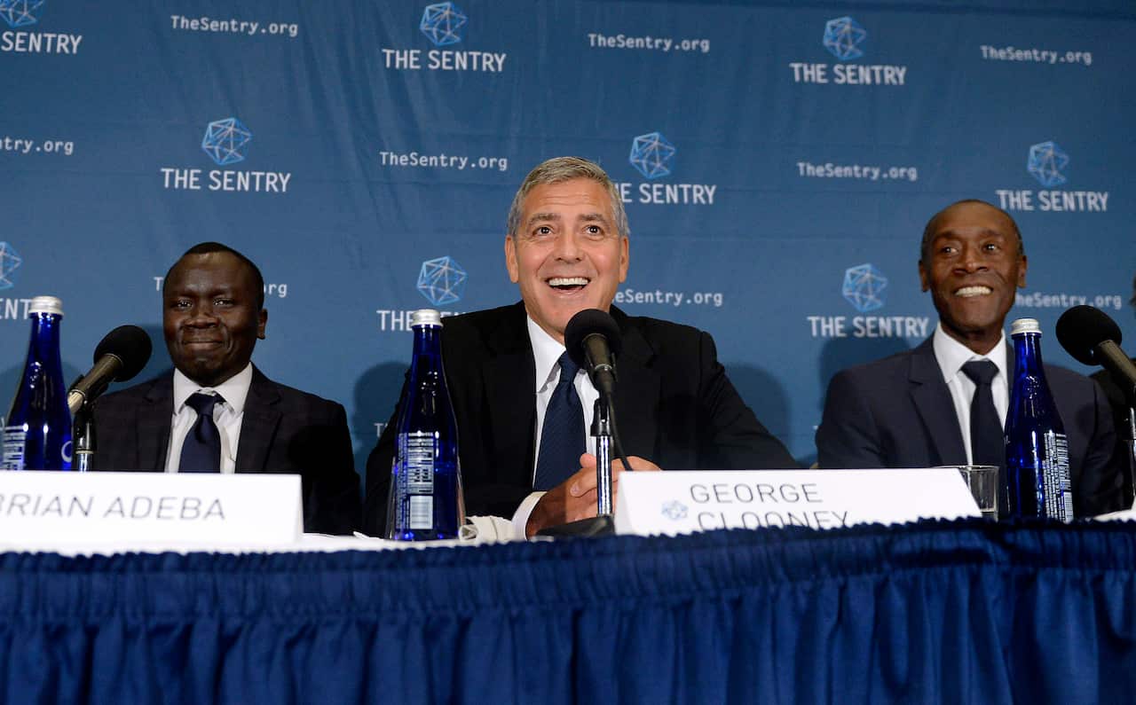 Actors George Clooney and Don Cheadle (R) participate in a news conference for the release of 'The Sentry' report on South Sudan