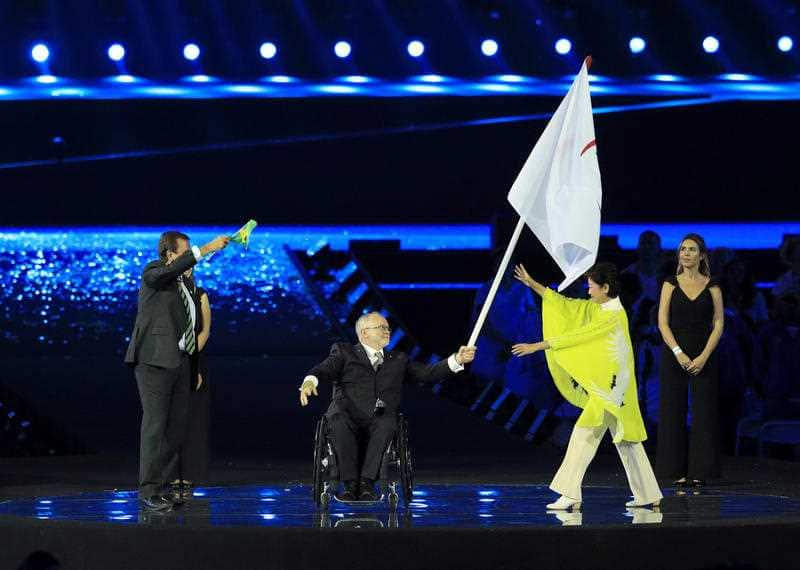 The Mayor of Rio de Janeiro Eduardo Paes (left) applauds as President of the IPC Sir Philip Craven (centre) hands the Paralympic flag to the Governor of Tokyo 
