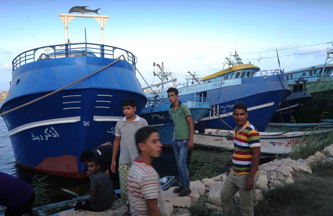Relatives of missing persons on the capsized boat gather as they wait for rescue workers, the port city of Rosetta, some 250km north of Cairo, Egypt