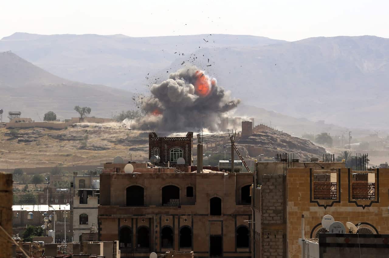 Smoke and balls of fire rise from an alleged Houthi-held military position after it was hit by a Saudi-led air strike in Sana'a, Yemen, 25 September 2016.