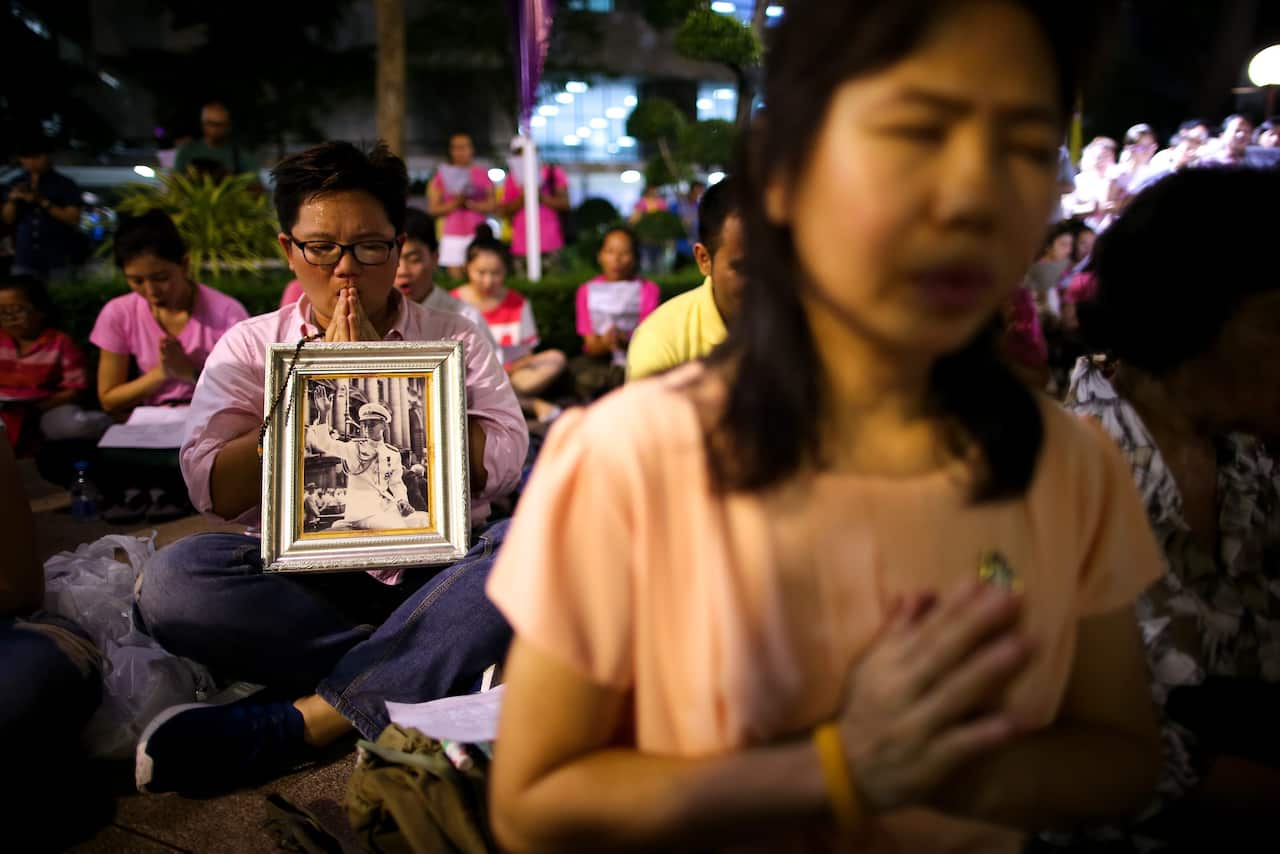 Thai well-wishers pray for a healthy recovery of Thai King Bhumibol Adulyadej at the Siriraj Hospital in Bangkok, Thailand