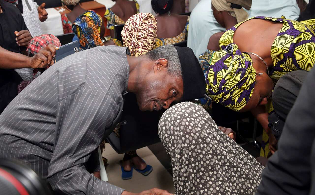 Nigeria Vice President ,Yemi Osinbajo, left, receives some of the freed Chibok school girls at the state House in Abuja, Nigeria, Thursday, Oct. 13, 2016.