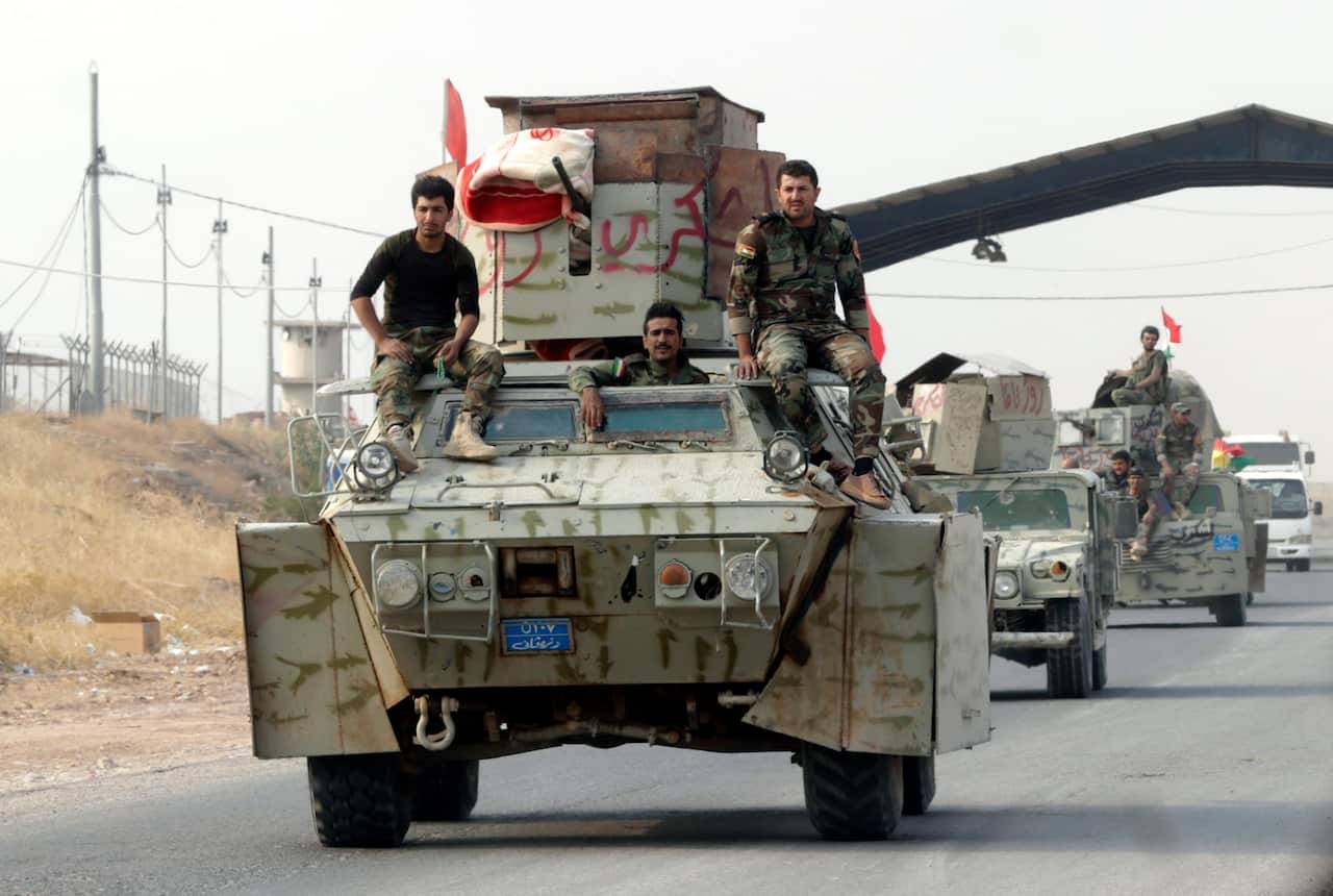 Iraqi Kurdish Peshmerga soldiers ride on their armored vehicles on the road of Erbil, the Capital of the Kurdistan region, Iraq.