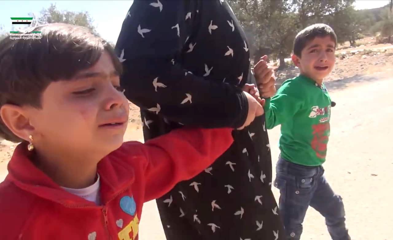 Children pulled by an adult after airstrikes killed over 20 people, mostly children, in the northern rebel-held village of Hass, Syria, Wednesday, Oct 26, 2016