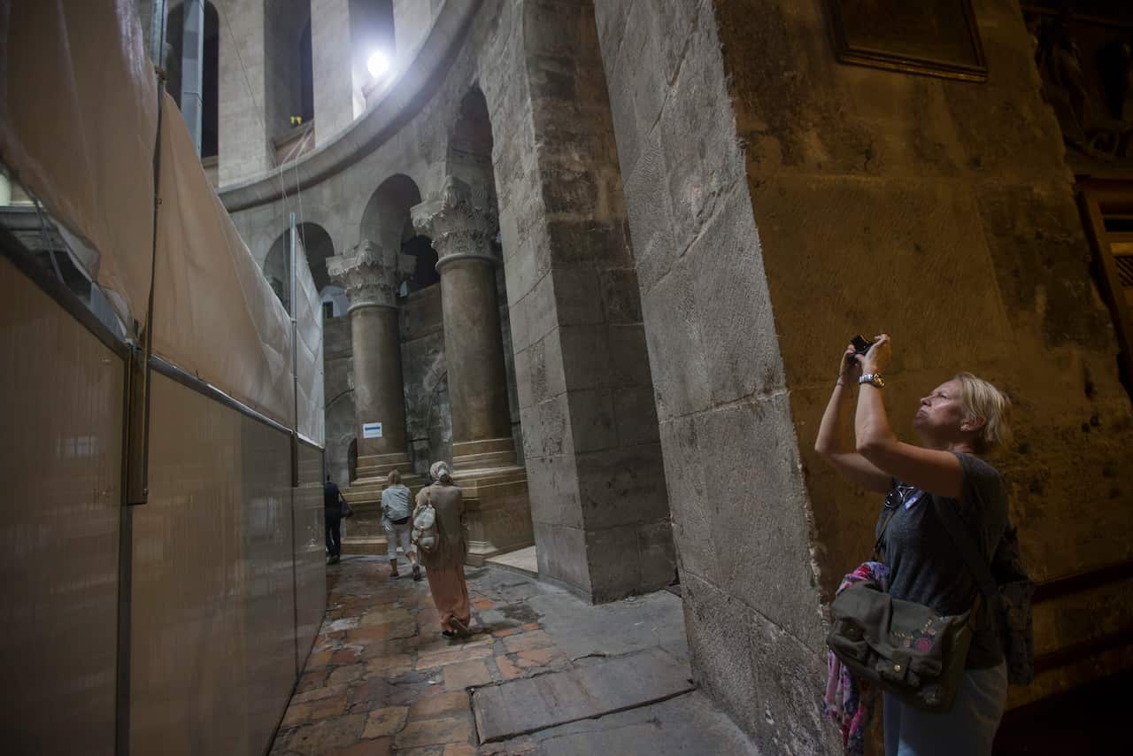 A tourist takes photos of the archaeology works at the tomb of Jesus Christ in the Church of the Holy Sepulchre, in the old city of Jerusalem, 28 October 2016.