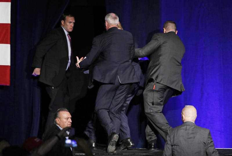 Secret Service agents pull Republican presidential candidate Donald Trump of the stage at a rally Saturday, Nov. 5, 2016, in Reno, Nev. (AP Photo/John Locher)