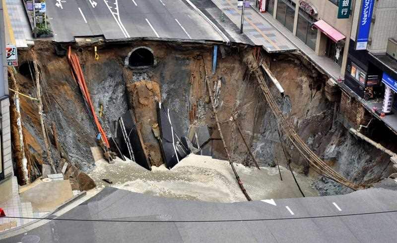 A huge sinkhole is pictured at a crossing near JR Hakata Station in downtown Fukuoka