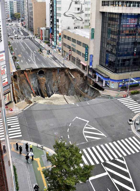 A massive sinkhole has opened up in the middle of the business district in Fukuoka, southern Japan.