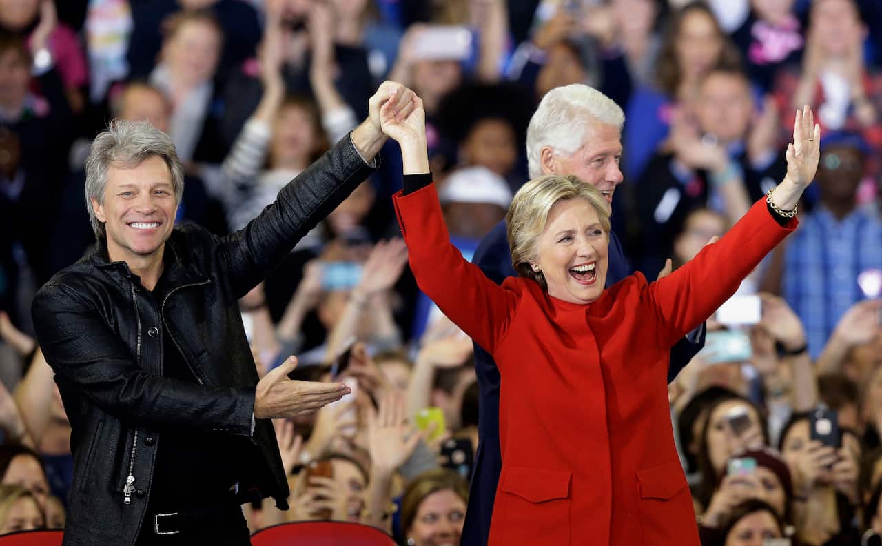 Democratic presidential candidate Hillary Clinton is joined by Jon Bon Jovi, left, and former President Bill Clinton during a campaign rally in  2016.