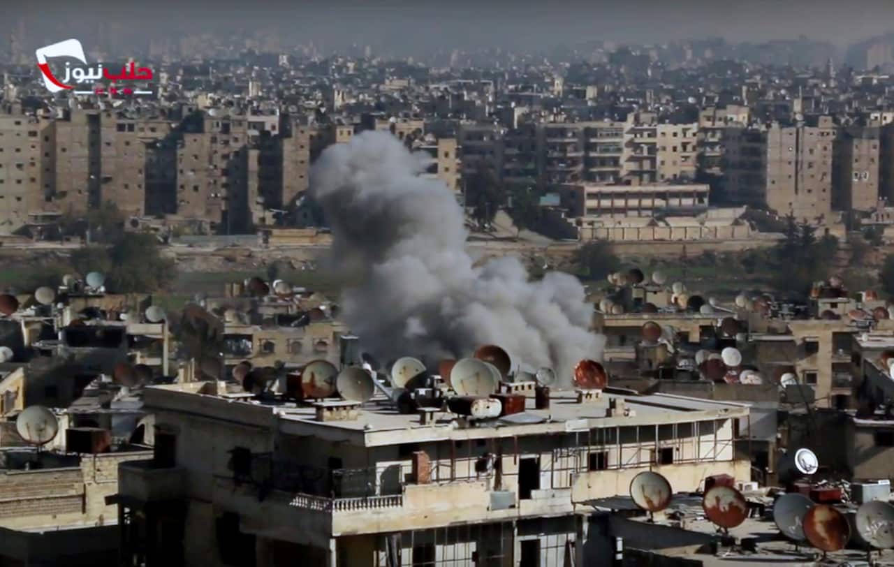This frame grab from video provided by the Aleppo News Network, shows smoke rising following an air strike that hit insurgents positions in Aleppo, Syria.