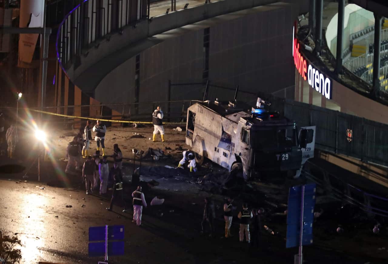 Crime scene investigators work next to a damaged water cannon at the scene of an explosion around Vodafone Arena Stadium in Istanbul.