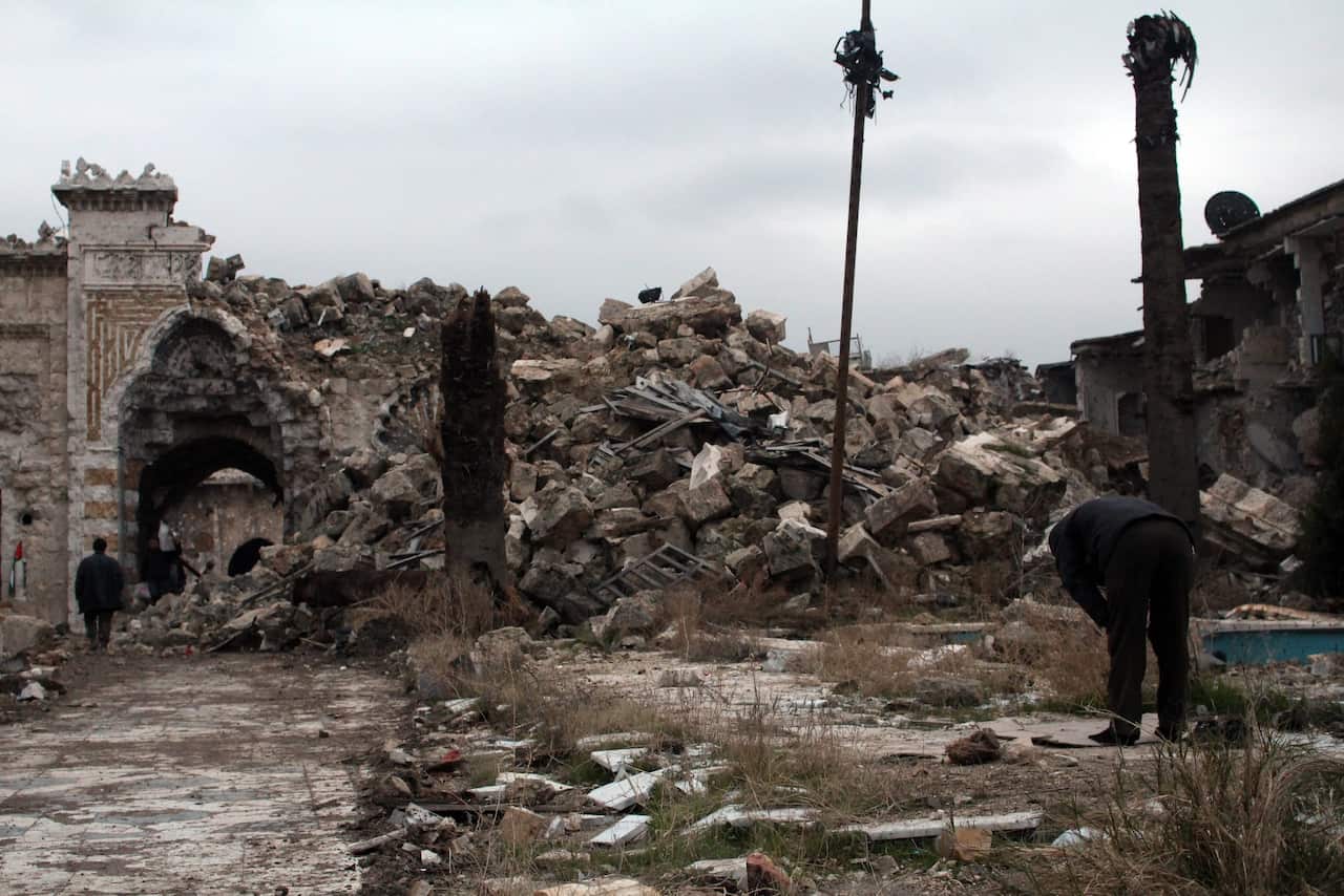 A man prays near the Umayyad Mosque in Aleppo, Syria
