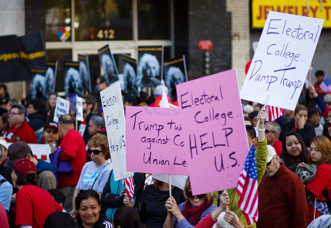 Protesters opposed to US President-elect Donald Trump call on the Electoral College to choose a different candidate.
